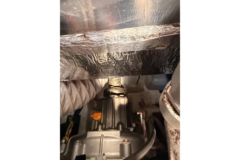 Slide: The Image of Engine compartment of a 2020 Beneteau Oceanis 30.1 sailboat, showing mechanical components. - 54