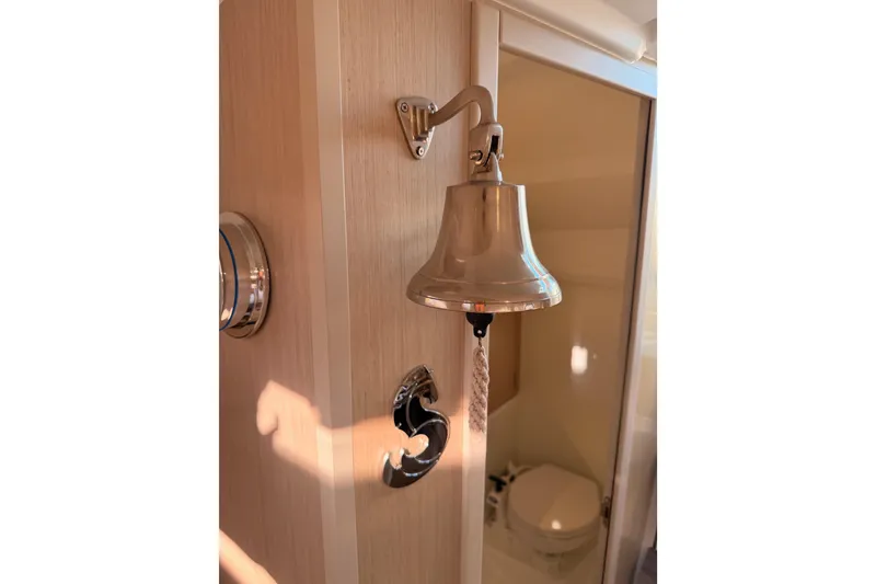 Slide: The Image of Interior of 2020 Beneteau Oceanis 30.1 yacht with bell and bathroom view. - 56