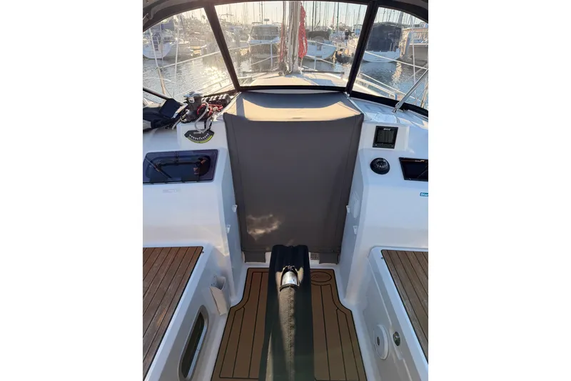Slide: The Image of Cockpit view of 2020 Beneteau Oceanis 30.1 sailboat, featuring teak flooring and marina backdrop. - 59