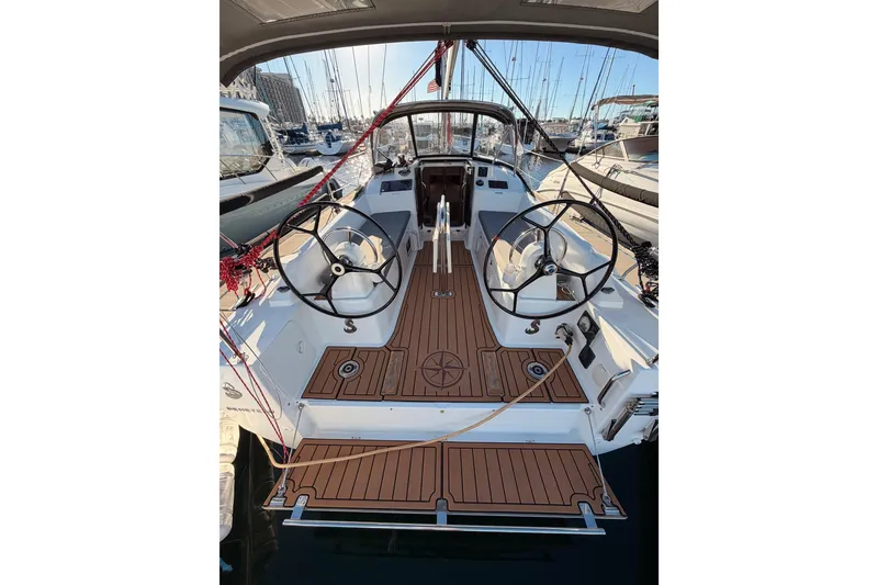 Slide: The Image of 2020 Beneteau Oceanis 30.1 yacht cockpit with dual steering wheels in marina. - 7