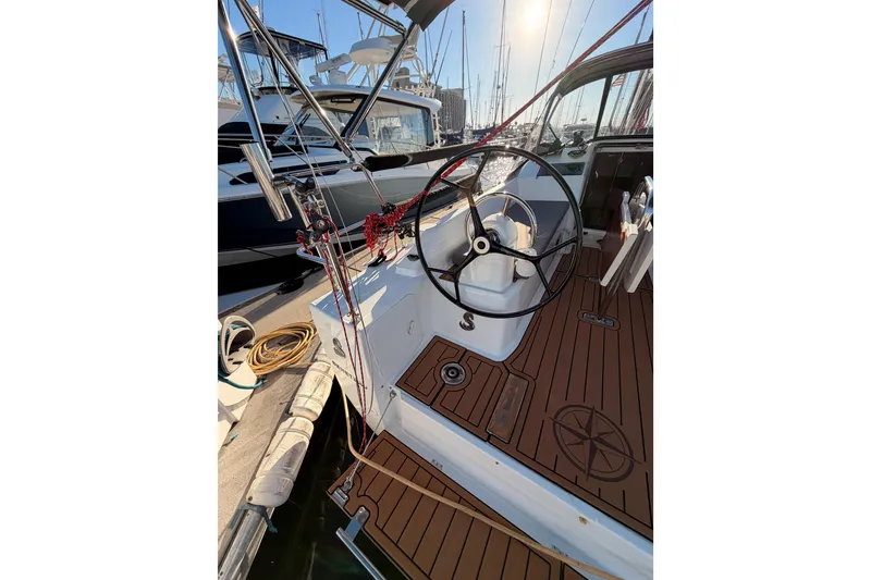 Slide: The Image of Cockpit of 2020 Beneteau Oceanis 30.1 sailboat with wooden deck and steering wheel. - 8
