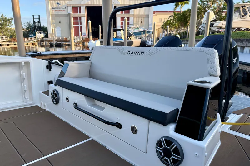 Slide: The Image of 2026 Navan S30 boat interior with cushioned seating and built-in speakers at a marina. - 10