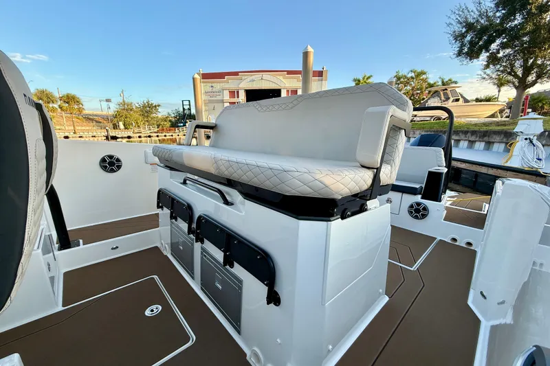 Slide: The Image of 2026 Navan S30 boat interior with cushioned seating and storage compartments. - 11