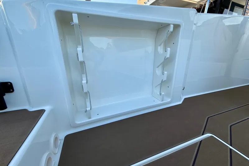Slide: The Image of Navan S30 2026 boat storage compartment with sleek white finish and modern design. - 14