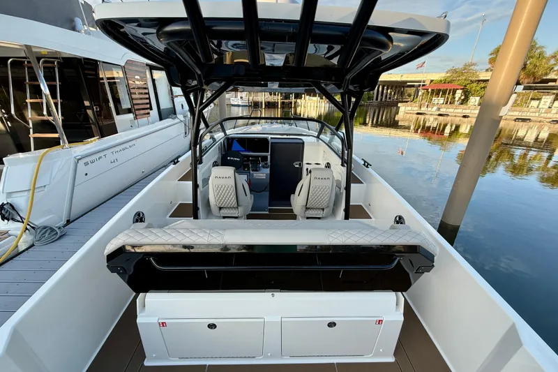 Slide: The Image of 2026 Navan S30 boat interior with modern seating and sleek design at a marina. - 16