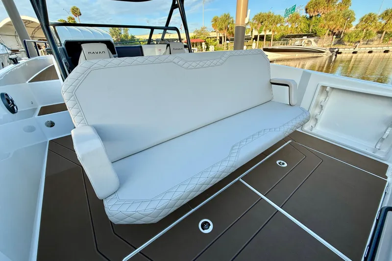 Slide: The Image of 2026 Navan S30 boat interior with white cushioned seating and brown flooring. - 17