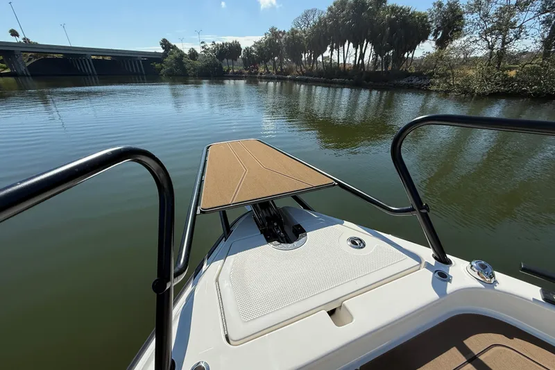 Slide: The Image of Bow view of 2026 Navan S30 boat on a calm river with trees and bridge. - 29
