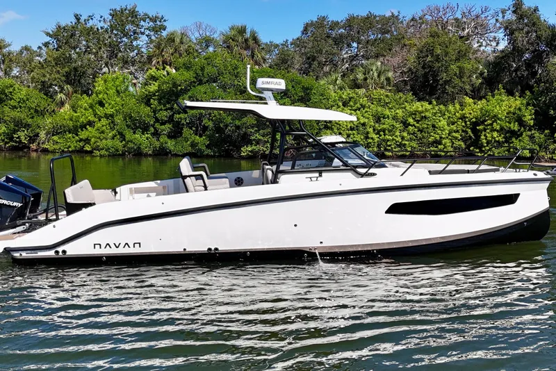 Slide: The Image of 2026 Navan S30 boat cruising on a serene waterway with lush greenery. - 3