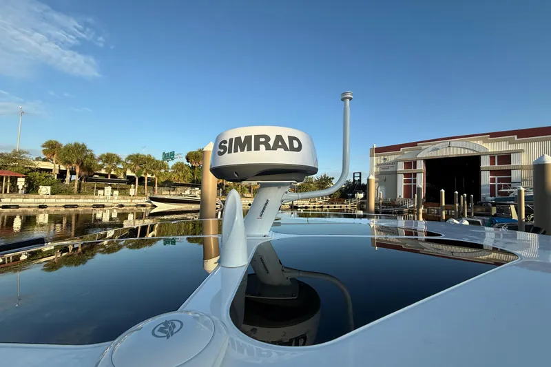 Slide: The Image of Navan S30 boat with Simrad radar, docked near a marina, 2026 model. - 34