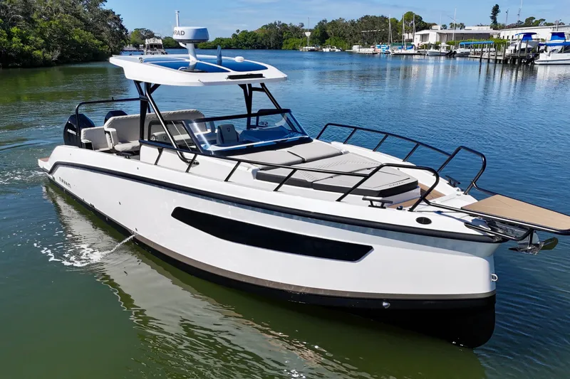 Slide: The Image of Navan S30 2026 boat cruising on a serene lake with lush greenery. - 5