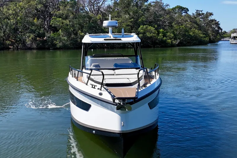 Slide: The Image of Navan S30 2026 boat cruising on a serene river surrounded by lush greenery. - 6