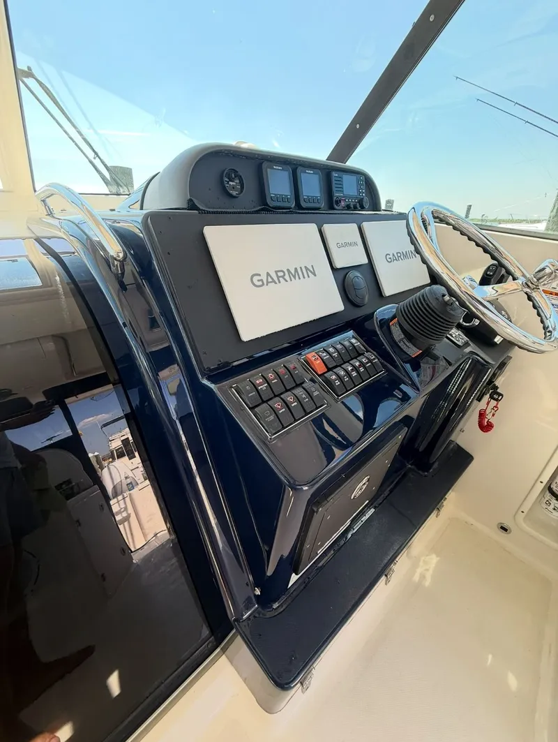 Slide: The Image of 2014 Pursuit OS 345 Offshore boat in harbor. - 2