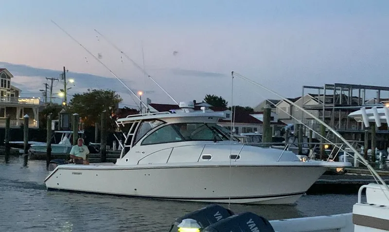 Slide: The Image of 2014 Pursuit OS 345 Offshore boat docked at sunset. - 20