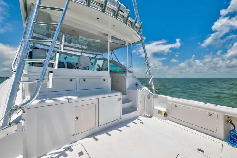 Slide: The Image of 2010 Cabo 45 Express yacht deck with ocean view under clear blue sky. - 11