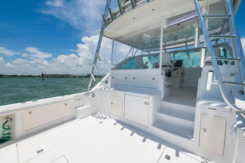 Slide: The Image of 2010 Cabo 45 Express yacht interior with helm, seating, and ocean view. - 12