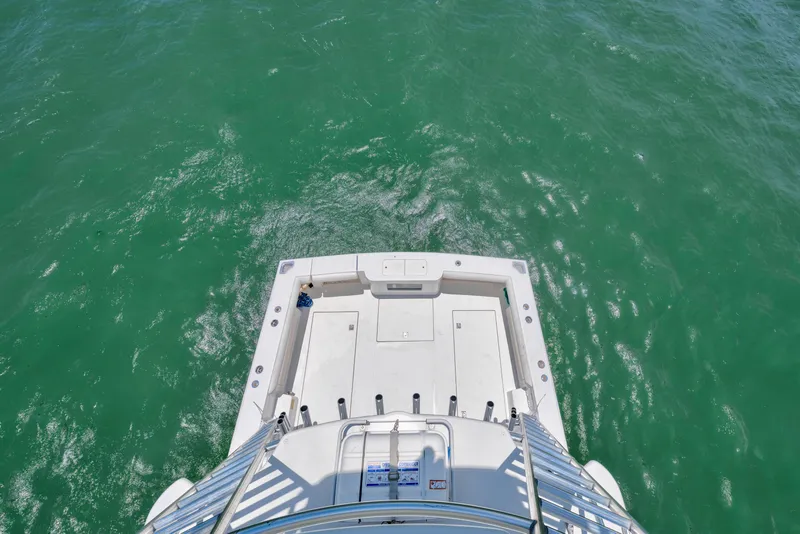 Slide: The Image of Aerial view of 2010 Cabo 45 Express boat deck on turquoise water. - 18