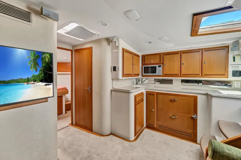 Slide: The Image of Luxurious 2010 Cabo 45 Express yacht interior with modern kitchen and cozy living space. - 21