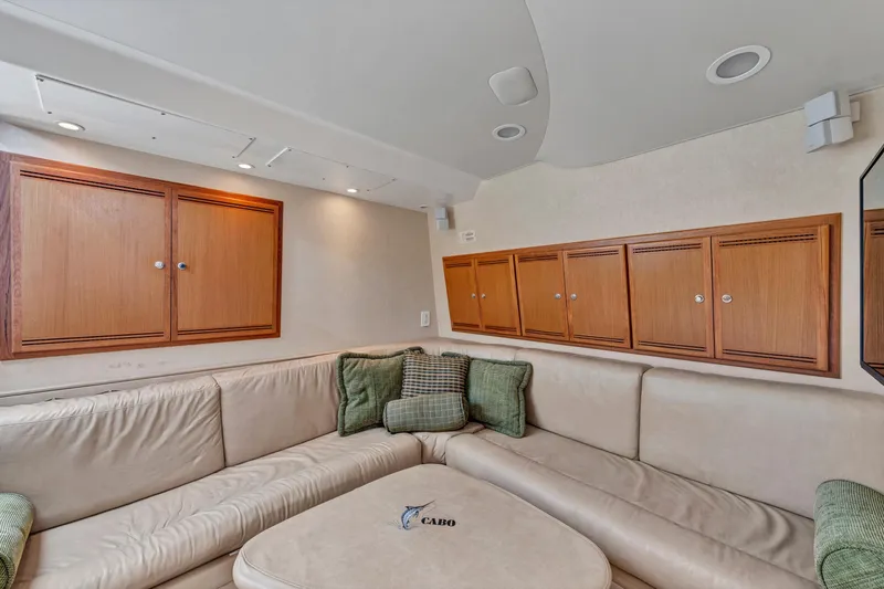 Slide: The Image of Luxurious interior of 2010 Cabo 45 Express yacht with beige seating and wooden cabinets. - 24