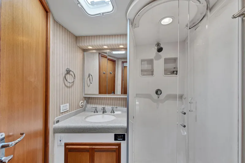 Slide: The Image of Luxurious 2010 Cabo 45 Express yacht bathroom with shower and vanity. - 28