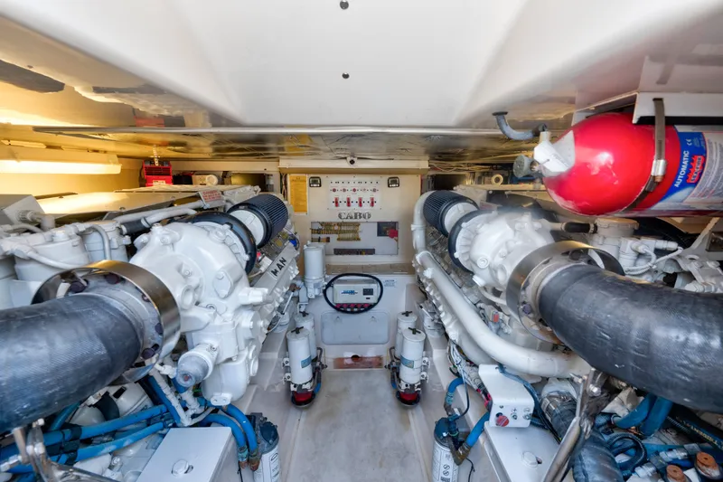 Slide: The Image of Engine room of 2010 Cabo 45 Express yacht with dual engines and fire extinguisher. - 31