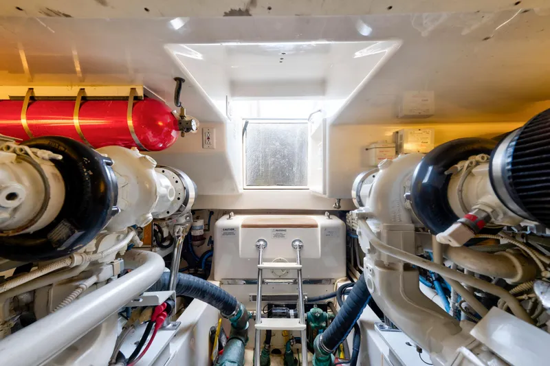 Slide: The Image of Engine room of 2010 Cabo 45 Express yacht, featuring dual engines and fire suppression system. - 33