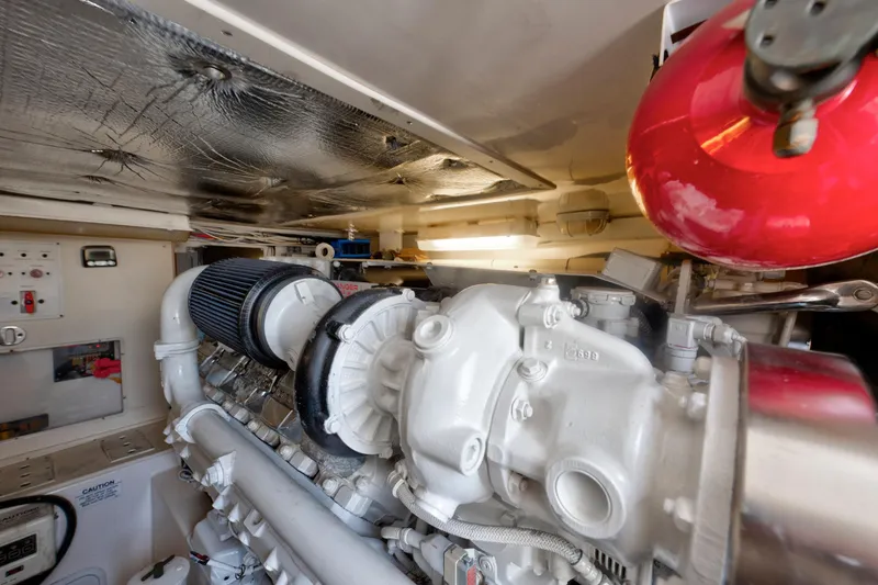 Slide: The Image of Engine room of 2010 Cabo 45 Express boat, featuring a powerful marine engine. - 35