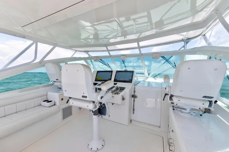 Slide: The Image of 2010 Cabo 45 Express yacht helm with modern navigation equipment and ocean view. - 6