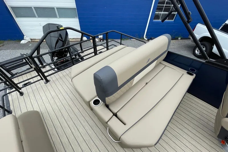 Slide: The Image of 2026 Starcraft EXS 5 Q DH boat with beige seating and cup holders. - 13