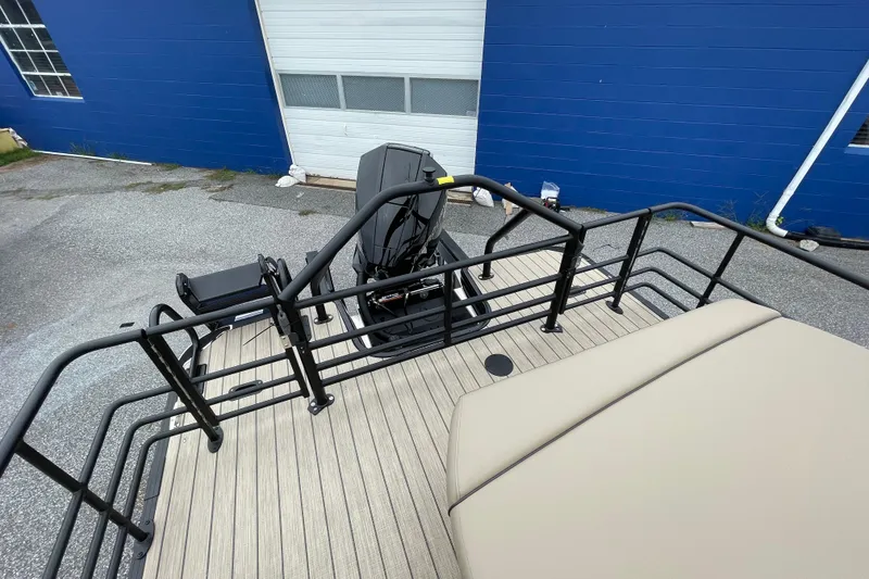 Slide: The Image of 2026 Starcraft EXS 5 Q DH boat with Mercury engine, beige seating, and trailer. - 17