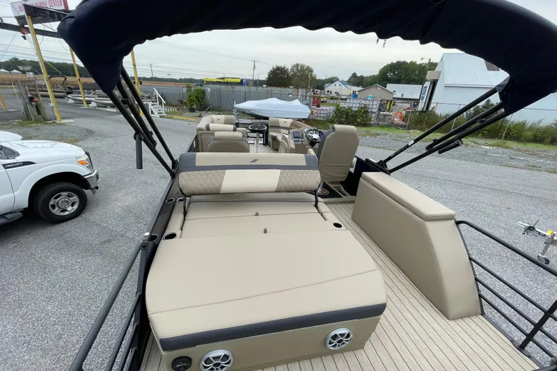 Slide: The Image of 2026 Starcraft EXS 5 Q DH pontoon boat with outboard motor in a marine center lot. - 20