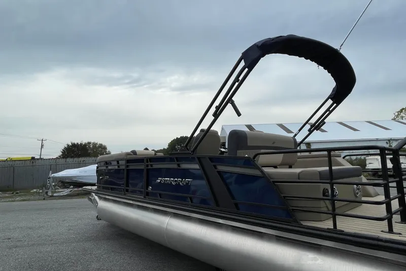 Slide: The Image of 2026 Starcraft EXS 5 Q DH boat with beige seating and sleek design. - 4
