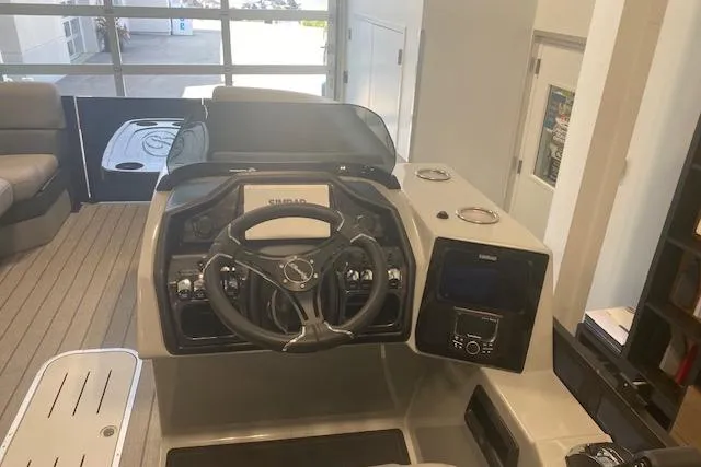 Slide: The Image of 2026 Bentley Pontoons Elite 223 Swingback dashboard with steering wheel and controls. - 11