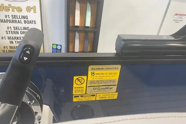 Slide: The Image of Bentley Pontoons Elite 223 Swingback 2026 dashboard with capacity warning label. - 13