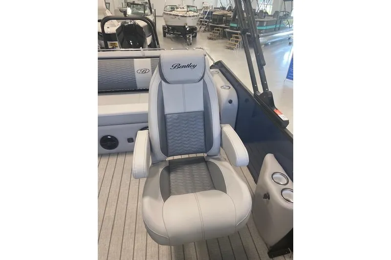 Slide: The Image of 2026 Bentley Pontoons Elite 223 Swingback captain's chair in a luxury boat interior. - 16