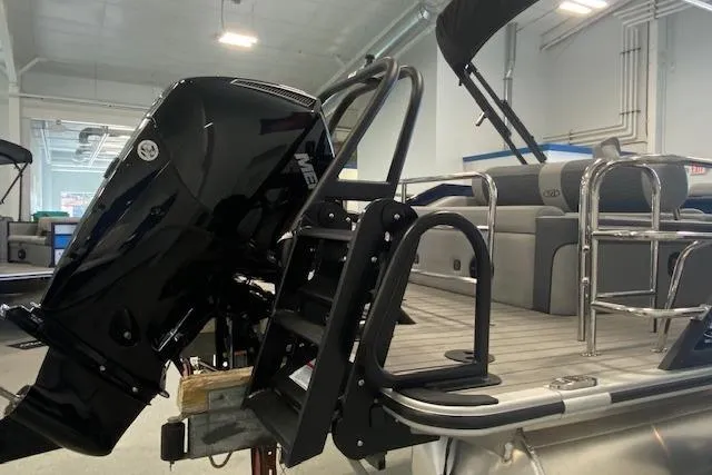 Slide: The Image of 2026 Bentley Pontoons Elite 223 Swingback with powerful outboard motor and sleek design. - 5