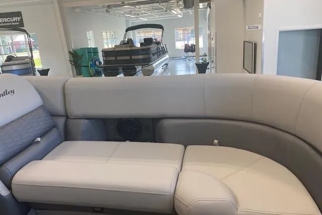 Slide: The Image of 2026 Bentley Pontoons Elite 223 Swingback interior with luxurious seating in showroom. - 8