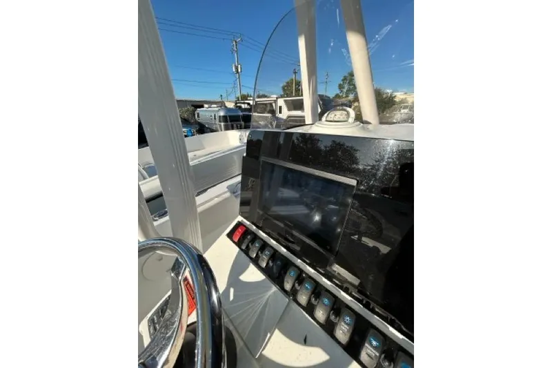 Slide: The Image of 2022 Sea Hunt Ultra 234 boat console with steering wheel and Garmin display. - 10