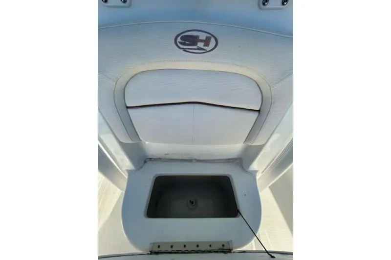 Slide: The Image of 2022 Sea Hunt Ultra 234 boat interior with white seating and blue sky background. - 12