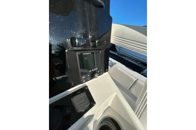 Slide: The Image of 2022 Sea Hunt Ultra 234 boat interior with seating and console. - 14