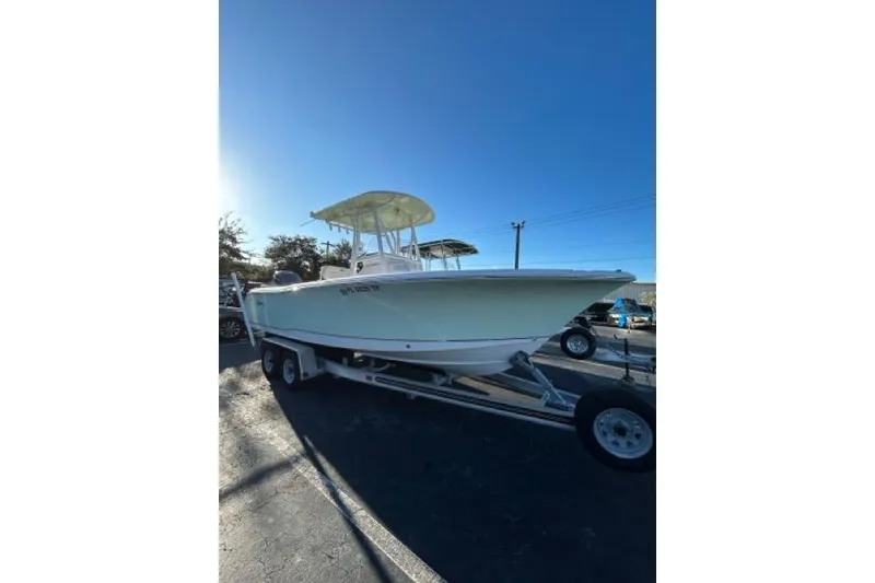 Slide: The Image of 2022 Sea Hunt Ultra 234 boat with Yamaha engine on trailer under clear blue sky. - 18