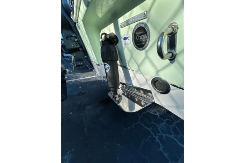 Slide: The Image of 2022 Sea Hunt Ultra 234 boat with Yamaha outboard motor, docked under clear blue sky. - 2