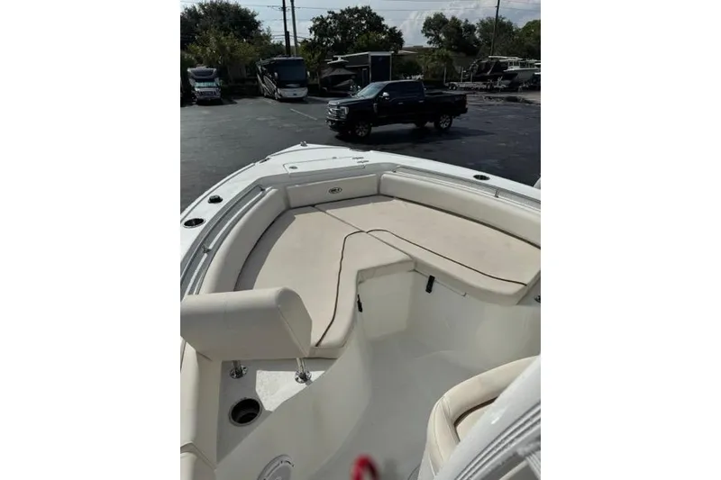Slide: The Image of 2022 Sea Hunt Ultra 234 boat interior with cushioned seating and sleek design. - 23