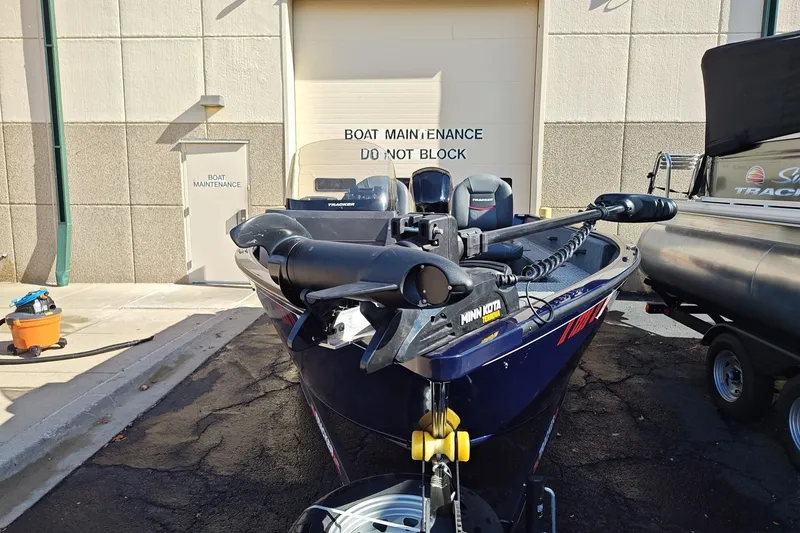 Slide: The Image of 2023 Tracker Pro Guide V-16 SC boat parked near maintenance area. - 3