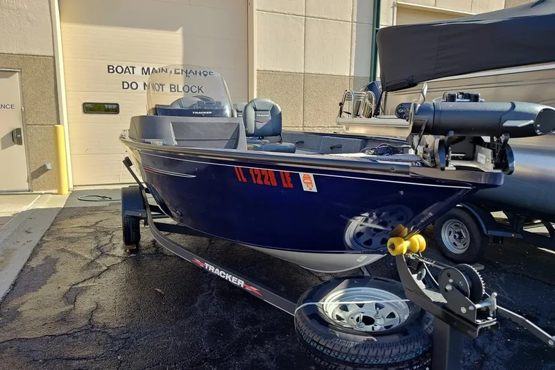 Slide: The Image of 2023 Tracker Pro Guide V-16 SC boat on trailer outside maintenance facility. - 4