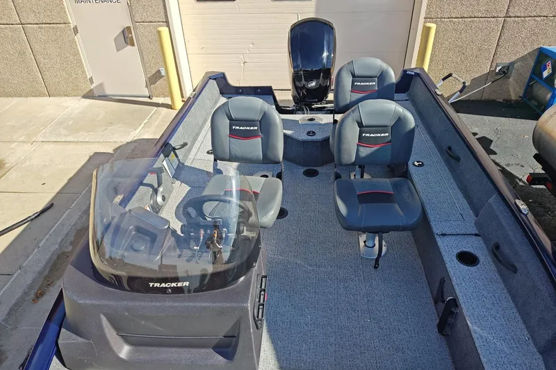 Slide: The Image of 2023 Tracker Pro Guide V-16 SC boat interior with seating and steering console. - 5