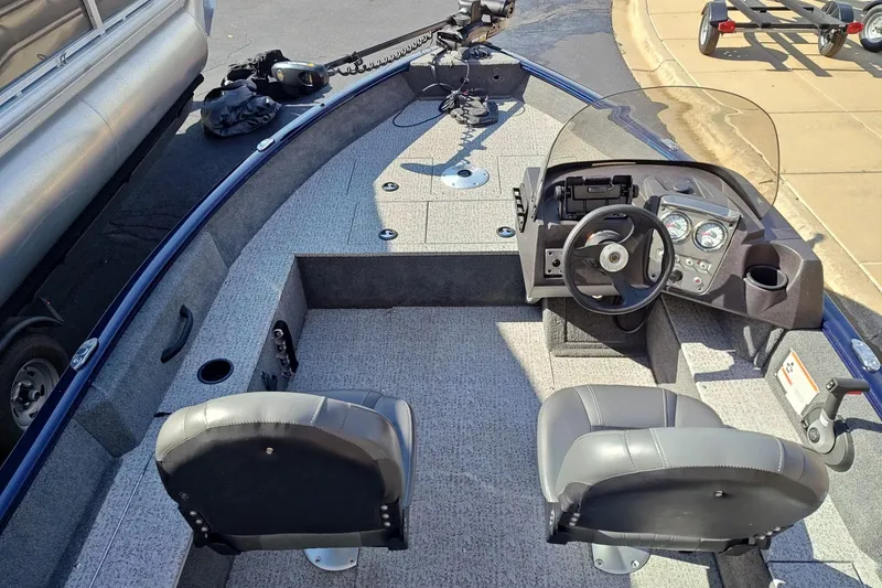 Slide: The Image of 2023 Tracker Pro Guide V-16 SC boat interior with steering console and seating. - 6