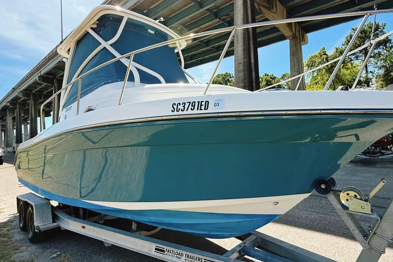 The Image of 2016 Century 2600 Walkaround boat on trailer under bridge, sunny day. - 0