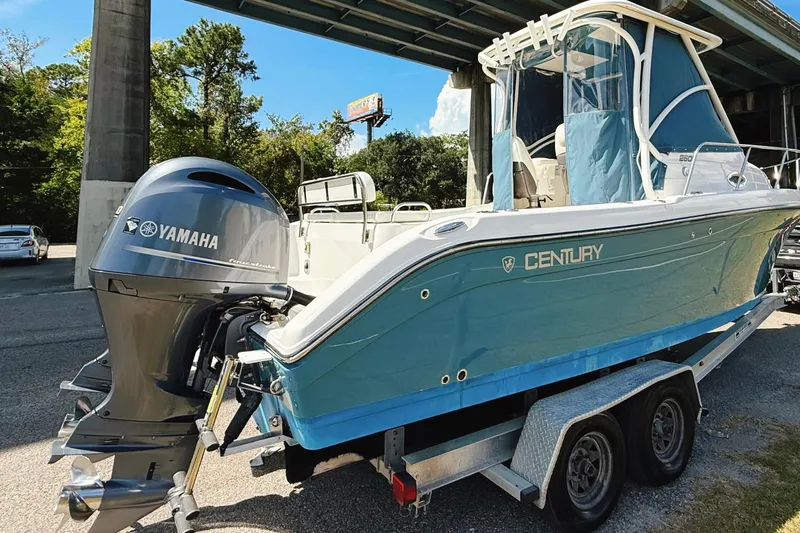 Slide: The Image of 2016 Century 2600 Walkaround boat with Yamaha engine on trailer under bridge. - 1