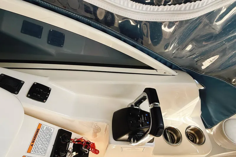 Slide: The Image of Century 2600 Walkaround 2016 boat interior with steering controls and cup holders. - 17