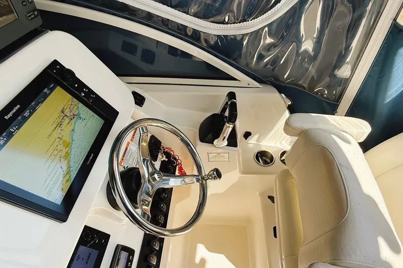 Slide: The Image of Interior view of 2016 Century 2600 Walkaround boat cockpit with navigation system. - 18